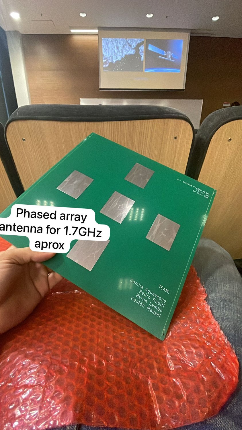 Phased-array antenna prototype board held inside an auditorium.