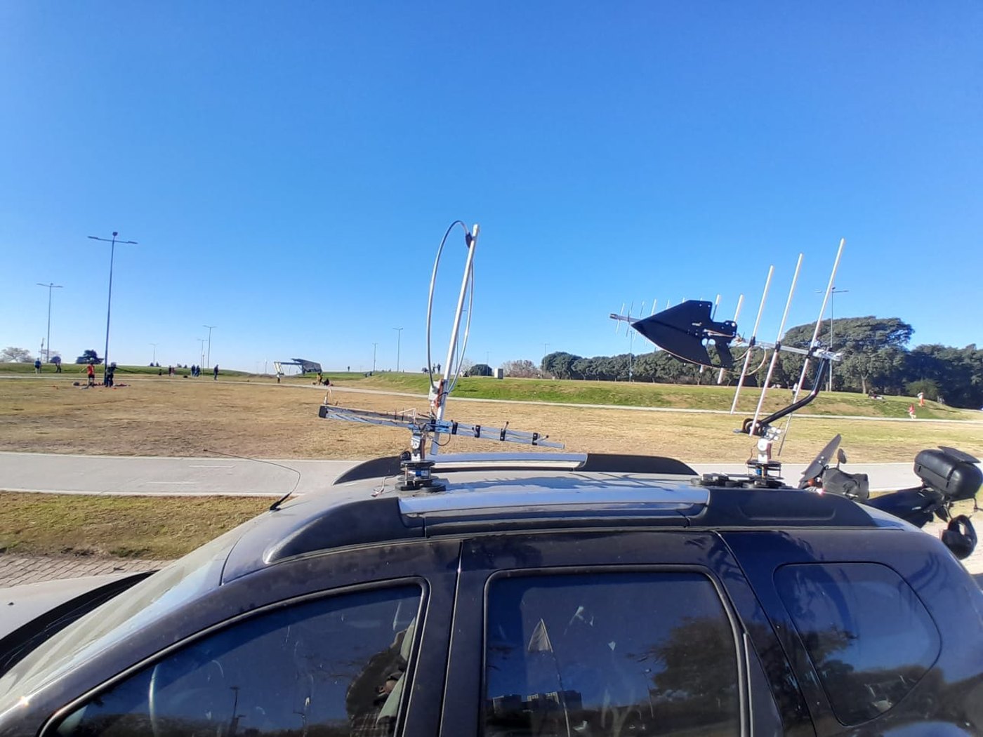 Vehicle roof with antennas and mounted RF equipment during field work.